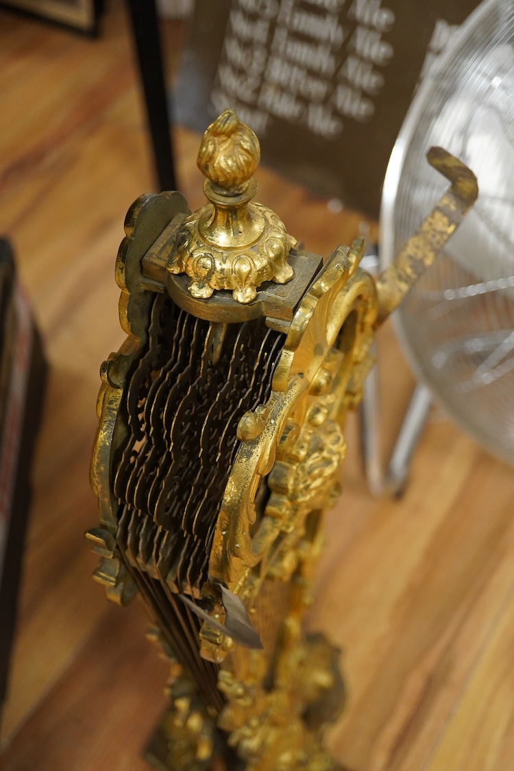 A 19th century cast gilt brass fan firescreen, 65cm high